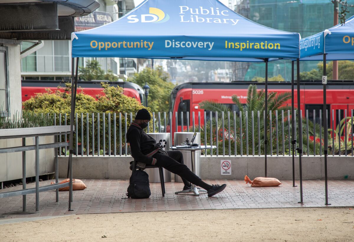 A patron at the San Diego Central Library partakes in the Computers in the Courtyard program on Tuesday, Jan. 5, 2021.