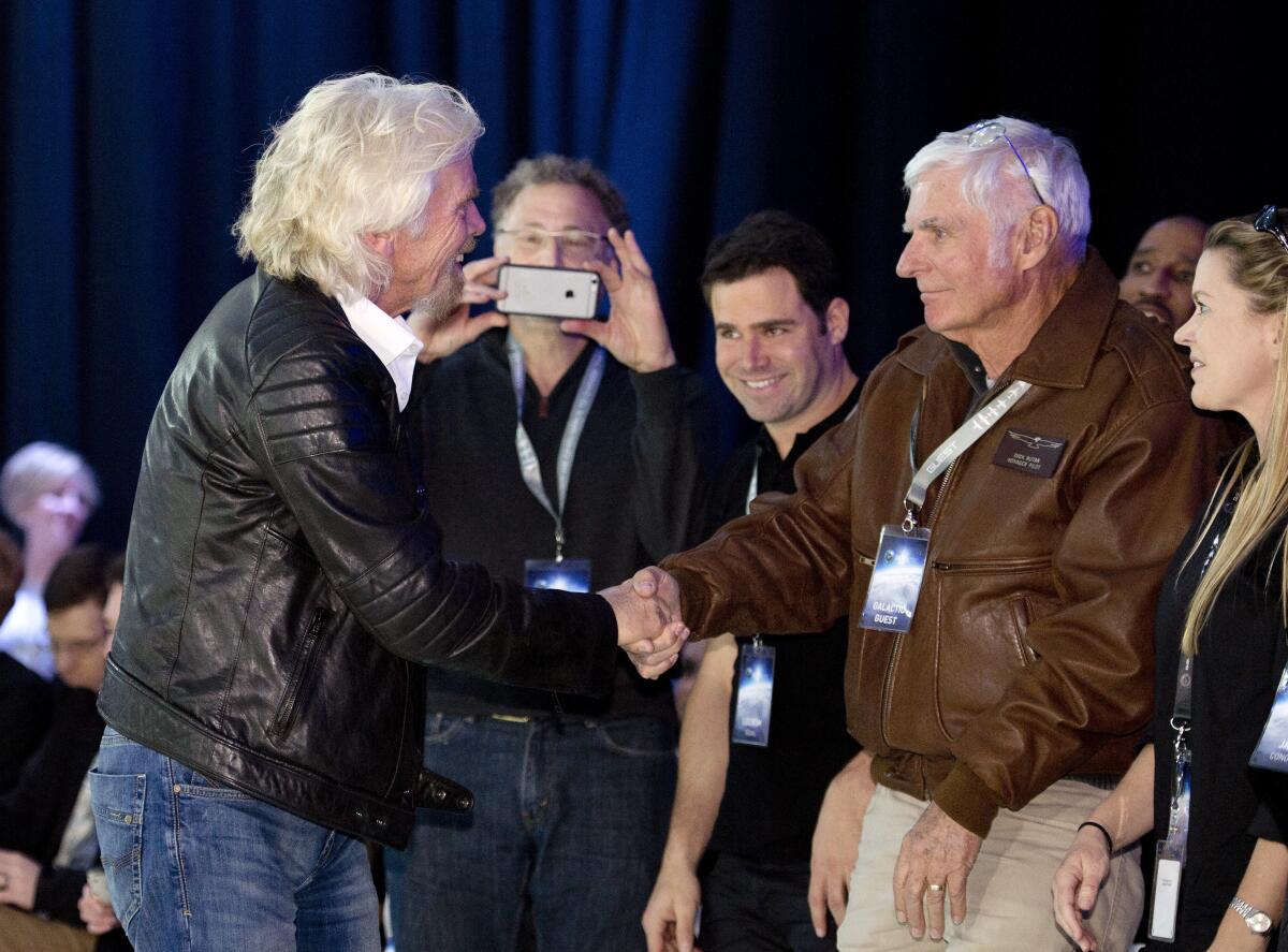 Richard Branson and Dick Rutan shake hands