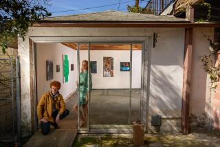 HIGHLAND PARK CA-FEBRUARY 15, 2024:Danny Bowman, left, and Alex Grunbeck are photographed at entrance to their art gallery, BOZOMAG, a converted garage located at their home in Highland Park. The current exhibition is called, "Nouveau Bozeaux." (Mel Melcon / Los Angeles Times)