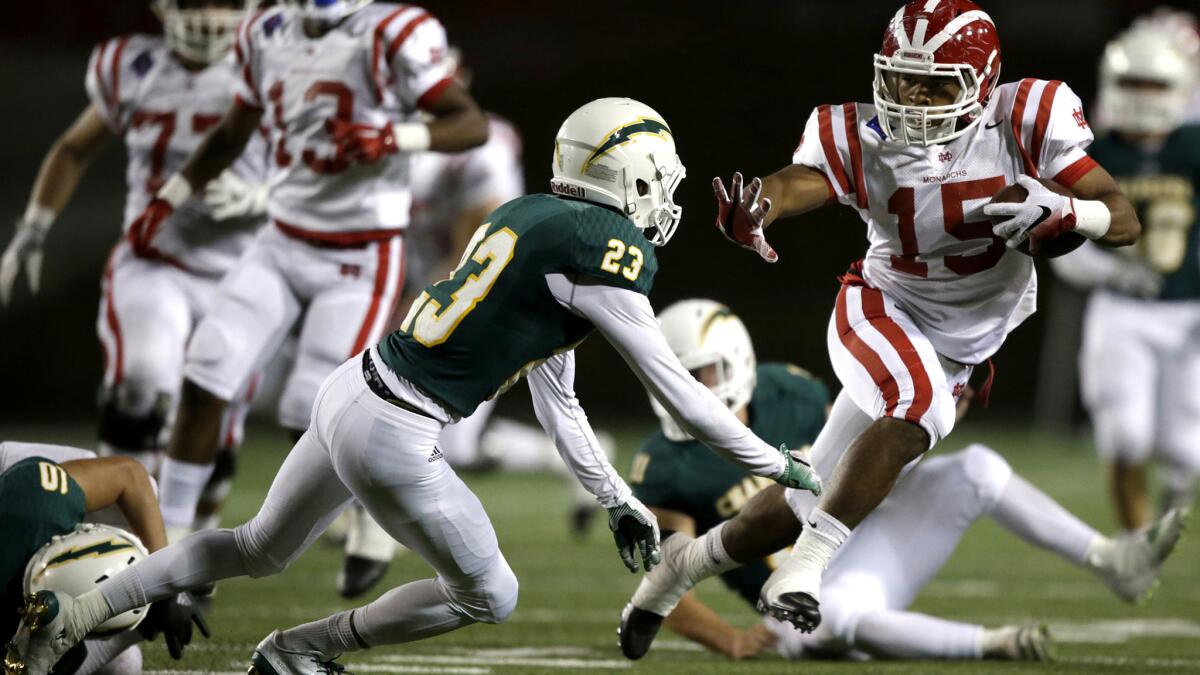 Mater Dei receiver John Jackson eludes Edison safety EJ Ginnis for a long gain Friday night.