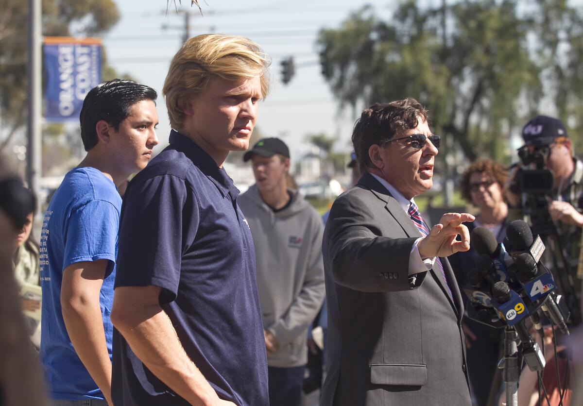 Orange Coast College student Caleb O'Neil, center, facing suspension after secretly recording a professor's comments about President Trump, listens as his attorney William Becker, right, speaks at a news conference Wednesday. Joshua Recalde-Martinez of OCC's College Republicans is at left.