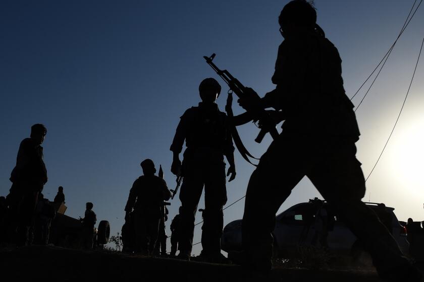 Afghan military personnel patrol an area in Kunduz province, which has a strong Taliban presence. The Taliban on Monday claimed an American soldier was killed in a roadside bombing in Kunduz.