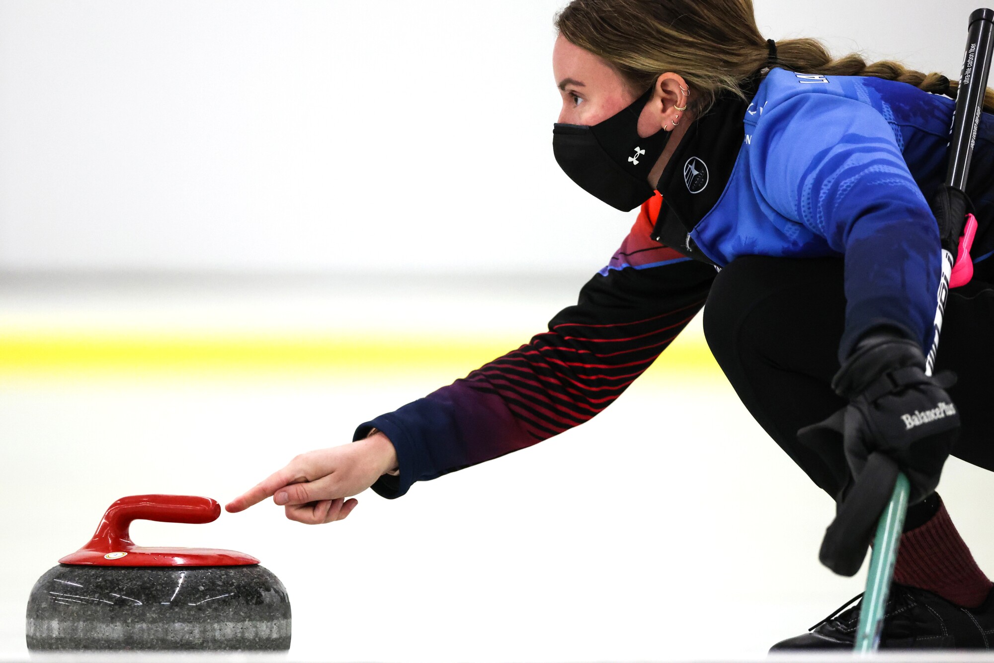 Amanda Landrian Gonzalez pushes off to throw a stone during Hollywood Curling Club league night.