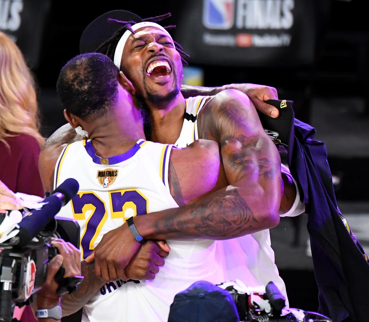 Lakers LeBron James and Dwight Howard embrace after their championship win.