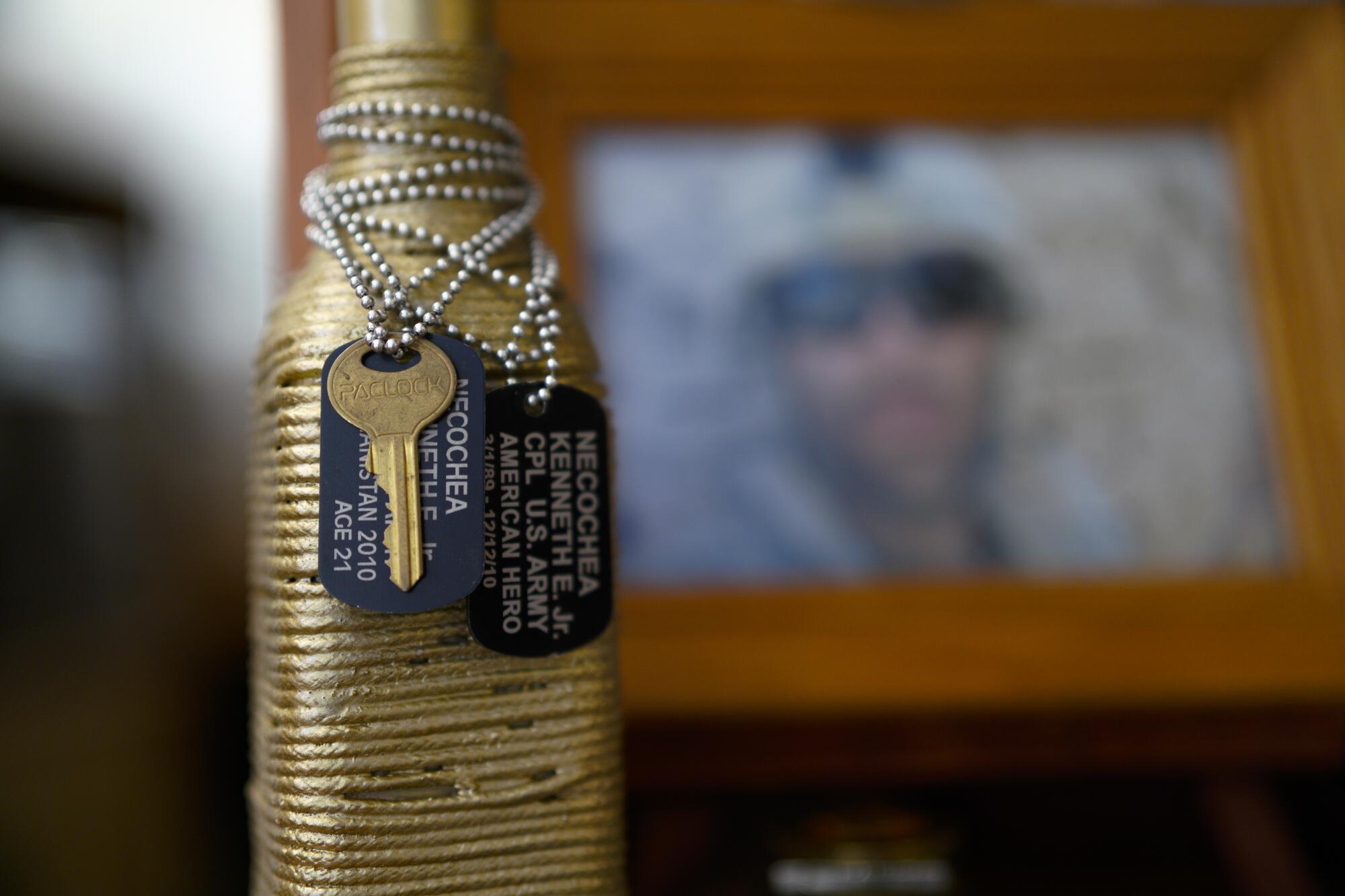 Two military dog tags and a key