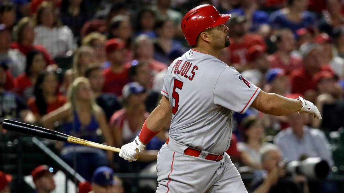 Angels' Albert Pujols hits three-run home run swing off against Texas on April 28.