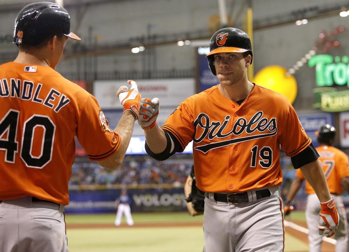 Baltimore's Chris Davis, right, celebrates his solo home run against Tampa Bay with teammate Nick Hundley on Sept. 6.