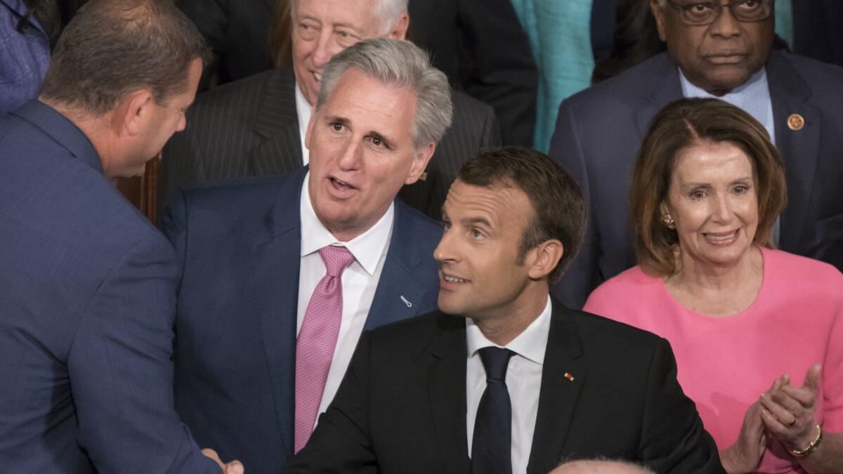 Congressional leaders Kevin McCarthy, second from left, and Nancy Pelosi, accompanying French President Emmanuel Macron, center, as he prepares to address Congress, represent vastly different constituencies.
