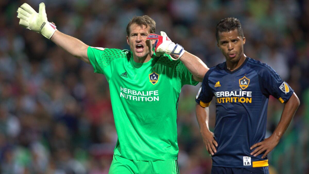 Galaxy goalkeeper Dan Kennedy and midfielder Giovani dos Santos react to a play during their game against Mexican club Santos on March 1.