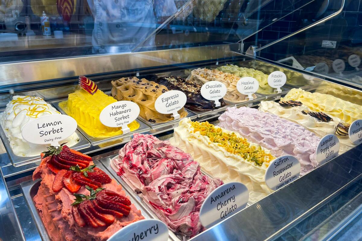 A case shows colorful types of gelato and sorbet. Labels include "mango habanero sorbet" and "saffron rosewater gelato."