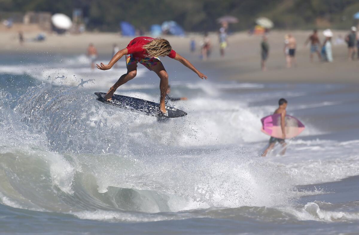 Blair Conklin competes in the professional division final of "The Vic" skimboarding championships Sunday at Aliso Beach.