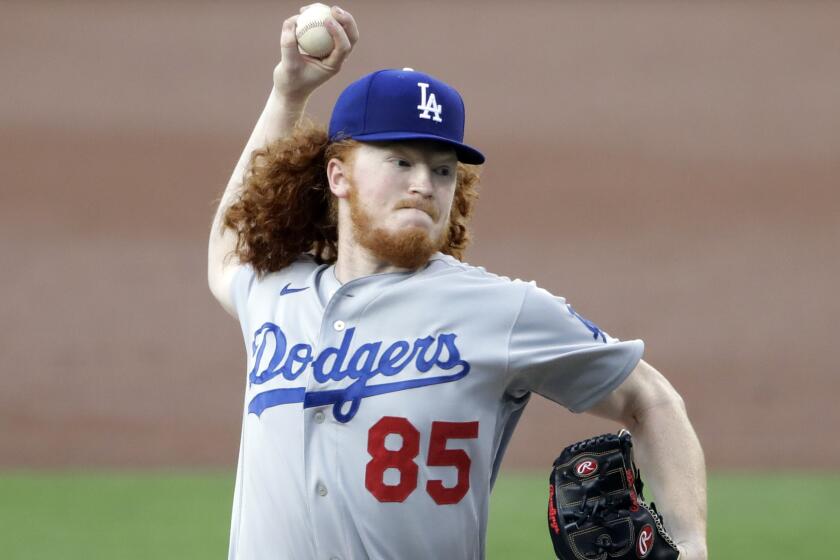 Los Angeles Dodgers starting pitcher Dustin May works against a San Diego Padres batter.