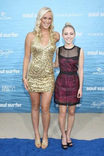 Bethany Hamilton, left, and her onscreen counterpart, AnnaSophia Robb, met up on the red carpet Wednesday night to celebrate the opening of their new biopic, "Soul Surfer." The movie tells the story of Hamilton's shark attack when she was 13 and how she bounced back from the tragedy and continued surfing, despite losing an arm.