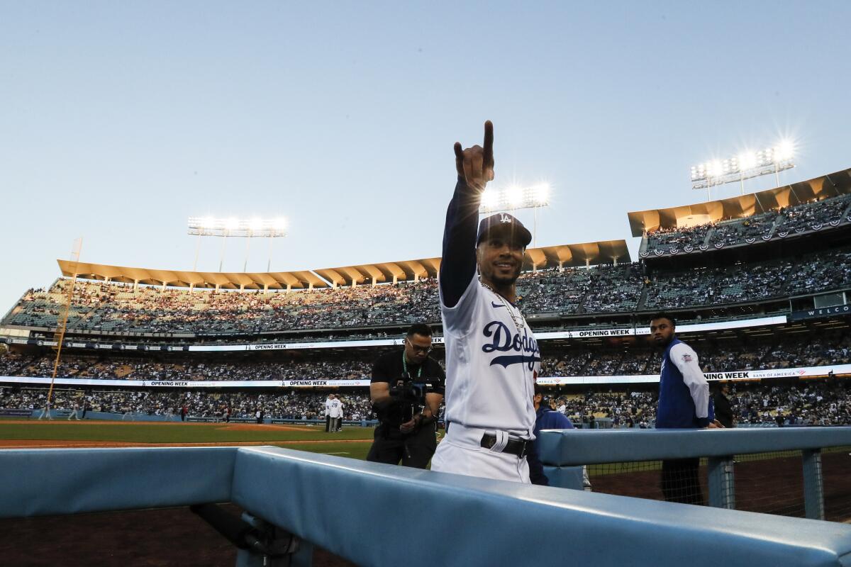 Dodgers right fielder Mookie Betts points to the stands at Dodger Stadium before a game against the Cincinnati Reds