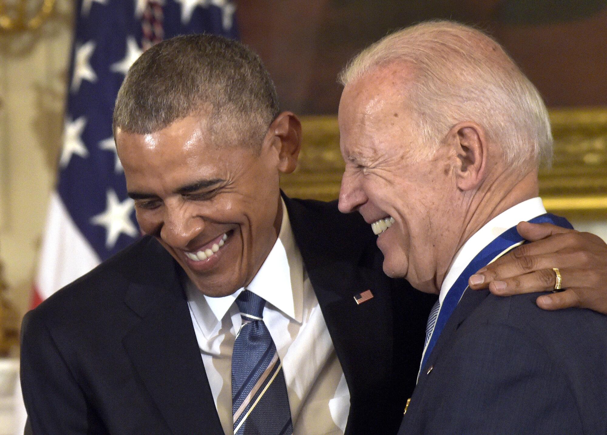 Biden laughs with President Obama, who was awarding him the Presidential Medal of Freedom with Distinction, in 2017.