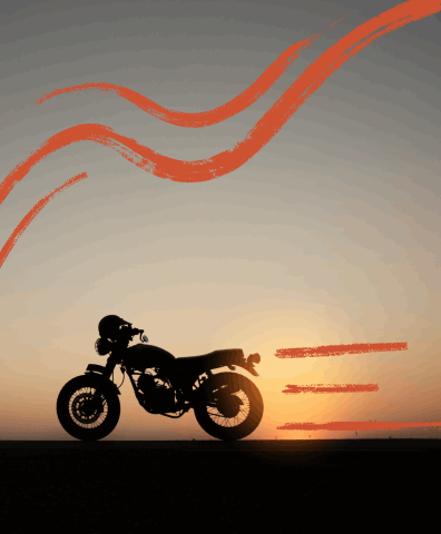 Motorcycle driving along a sunset.