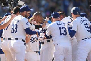 Los Angeles, CA - September 22: Los Angeles Dodgers' Mookie Betts celebrates with teammates.