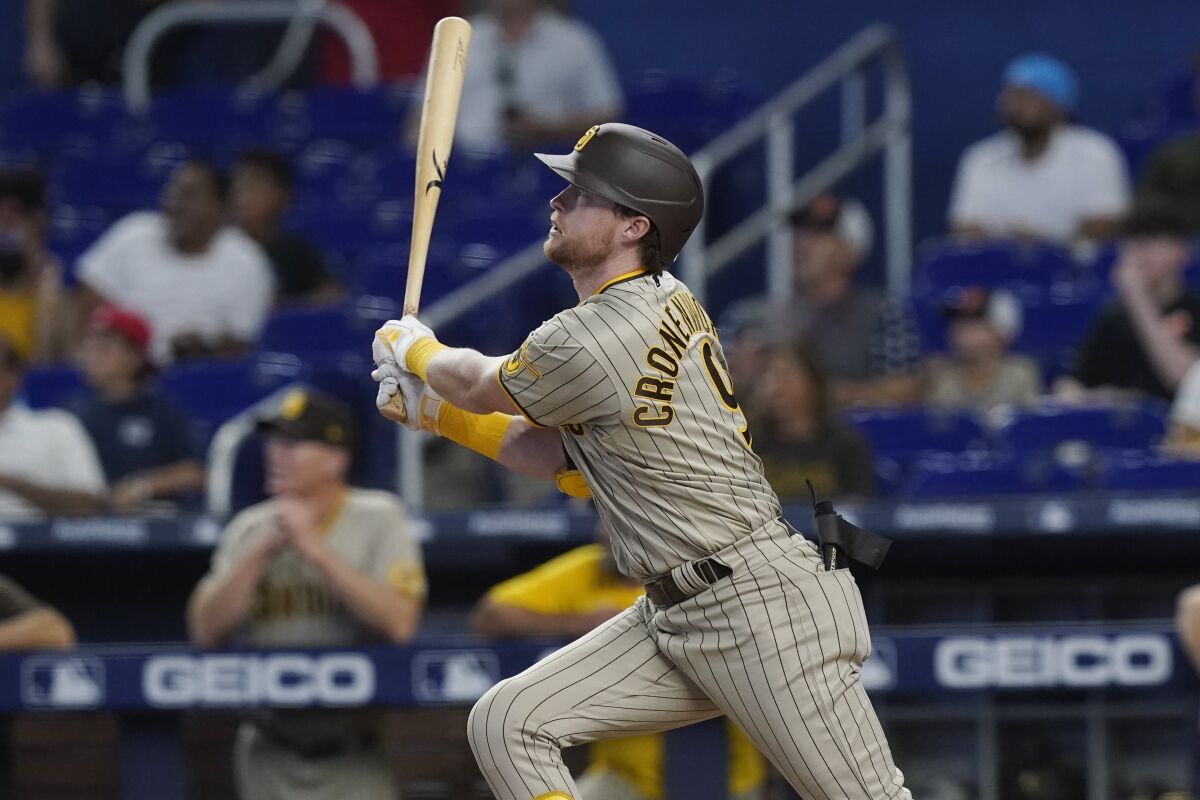 San Diego Padres' Jake Cronenworth (9) hits a grand slam in the first inning of a baseball game against the Miami Marlins, Wednesday, Aug. 17, 2022, in Miami. (AP Photo/Marta Lavandier)