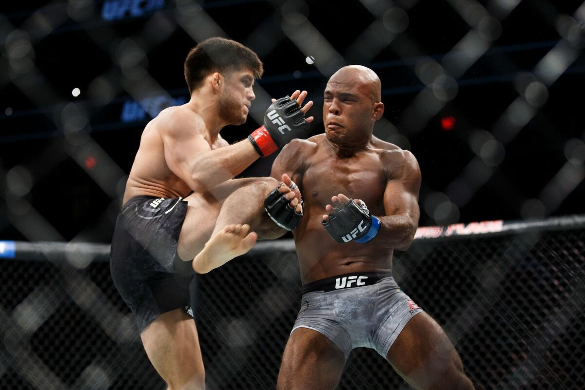 Henry Cejudo, left, tries to knee Wilson Reis during their fight at UFC 215.