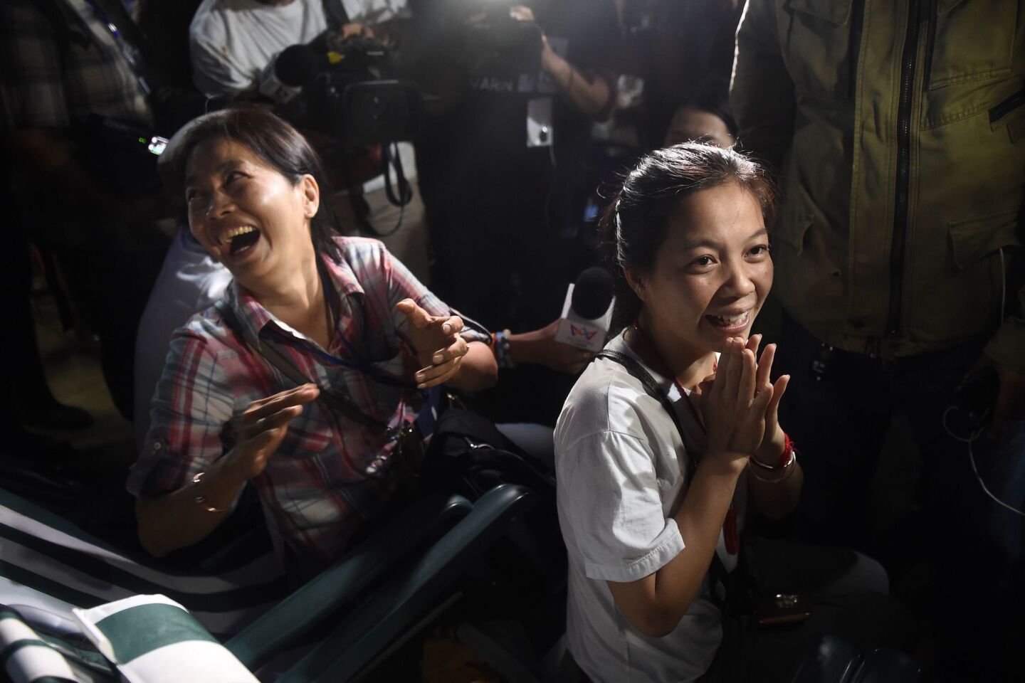 Relatives celebrate while camping out near Tham Luang Nang Non cave following news that the boys and their coach were found.