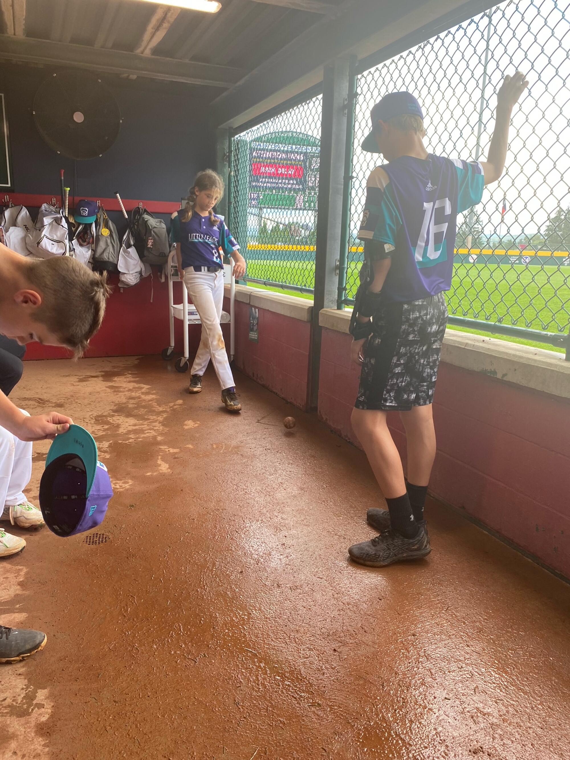 Ella Bruning waits during a rain delay in South Williamsport, Pa.