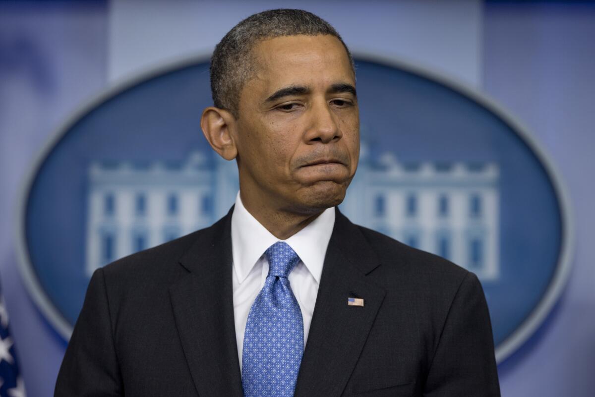 Obama pauses as he speaks about the fatal shooting of Trayvon Martin by George Zimmerman, during a daily news briefing at the White House on July 19, 2013.