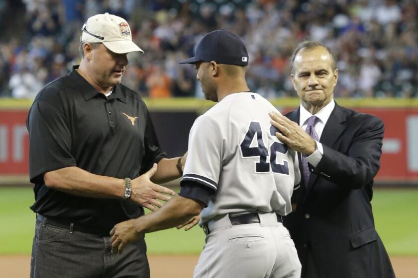 Mariano Rivera is greeted by Roger Clemens, left, and Joe Torre, right, before the final game of his career.