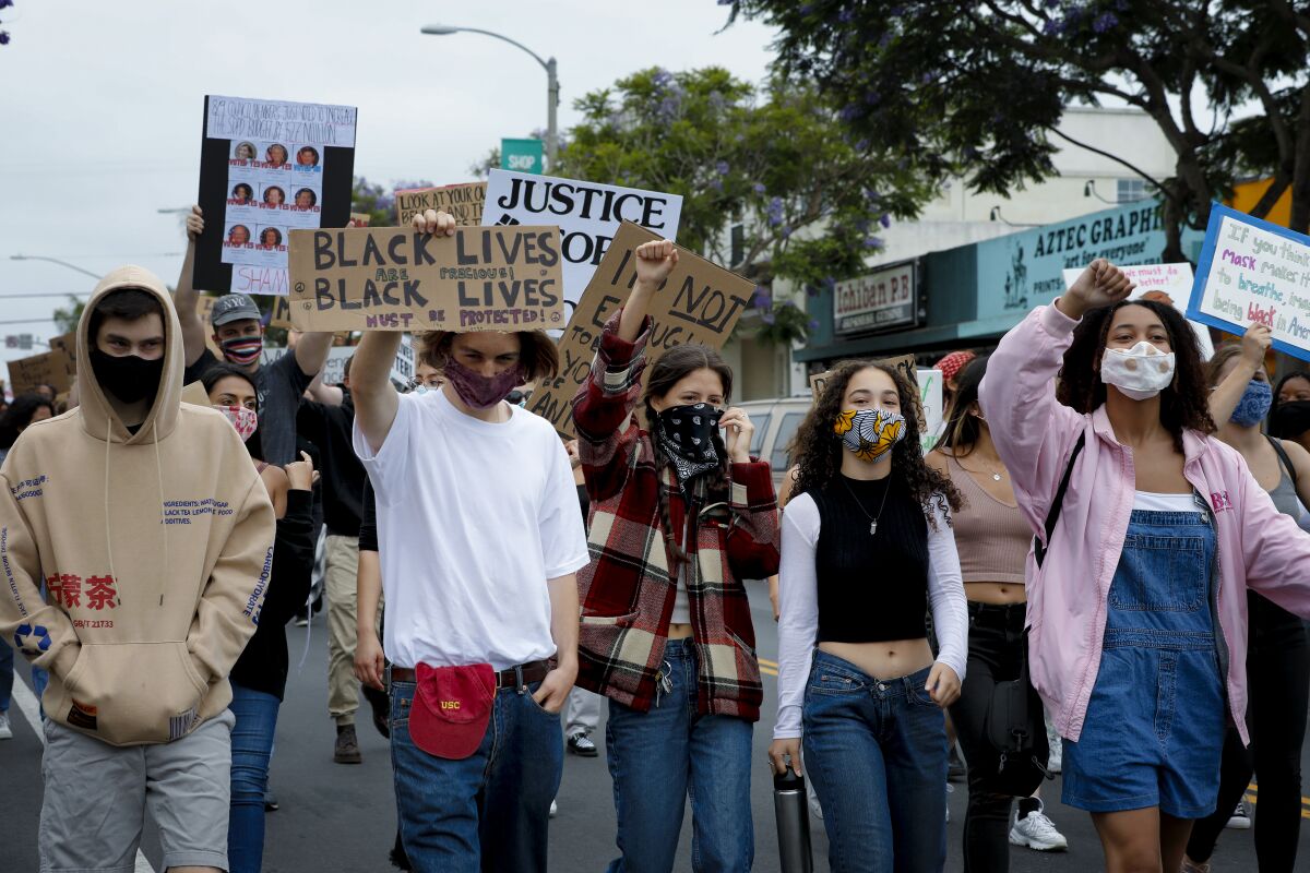 Protesters march down Garnet Avenue in Pacific Beach on June 24 to show support for the Black Lives Matter movement. 