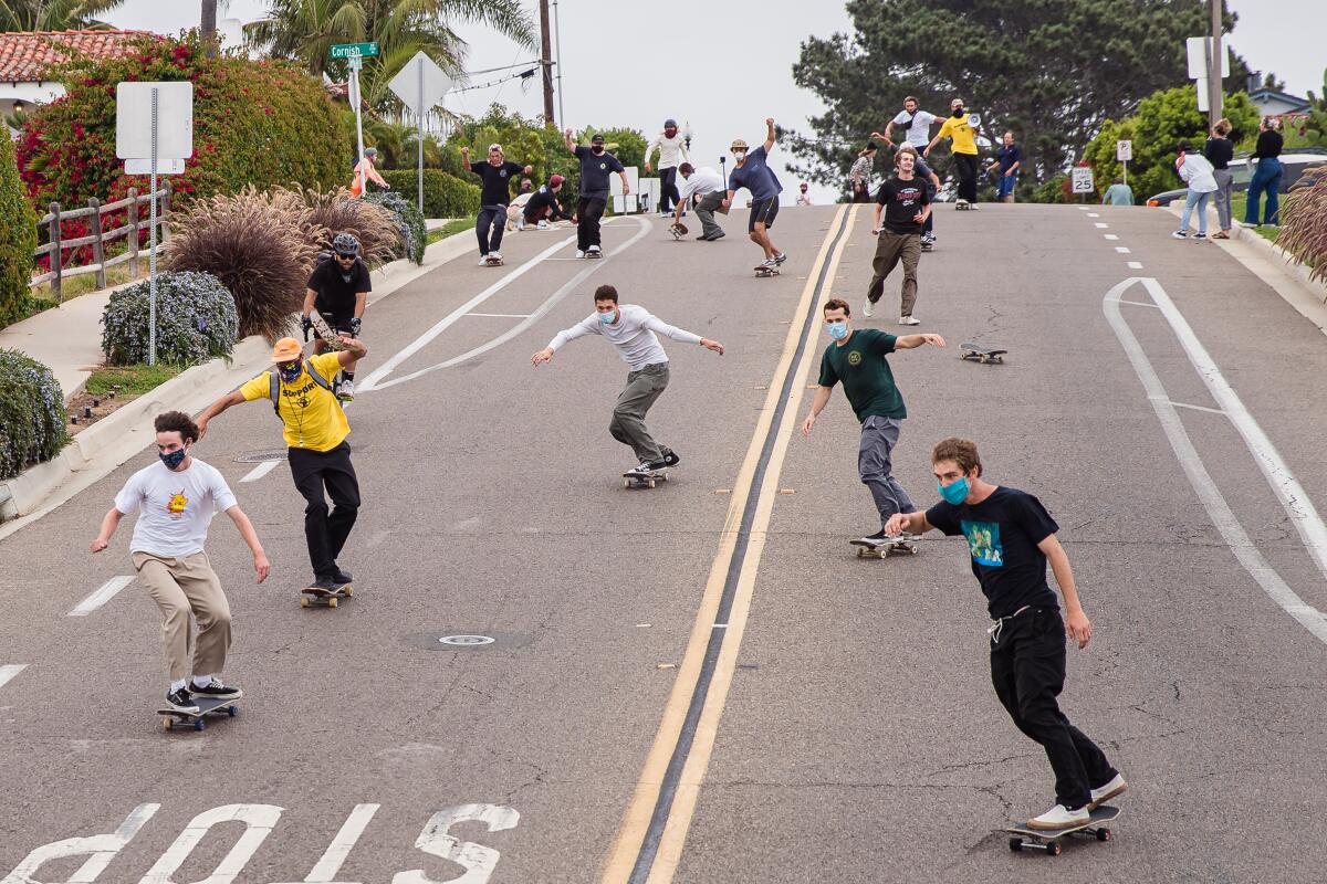 Skateboarders head down Santa Fe Drive in Encinitas for Sunday's protest.