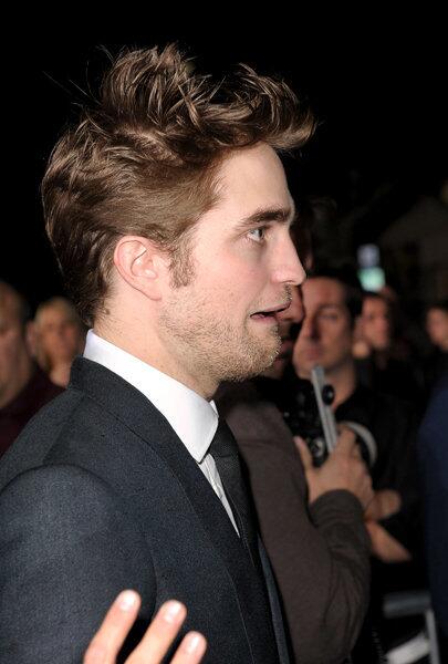 We can only assume that Robert Pattison looks so distraught because someone held up a mirror.