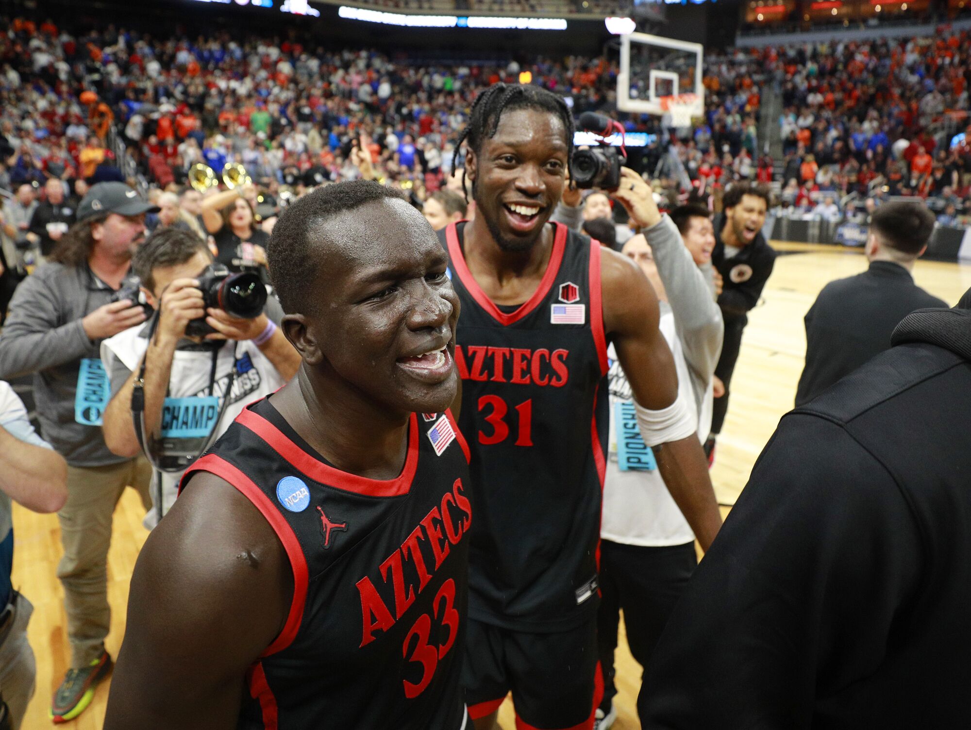 San Diego State's Aguek Arop and Nathan Mensah celebrate after a win against Alabama in a Sweet 16 game.
