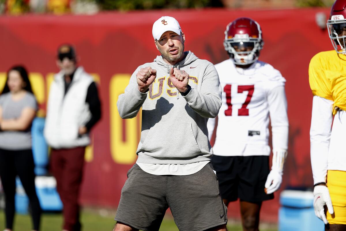 USC defensive coordinator Alex Grinch instructs players during practice in March.
