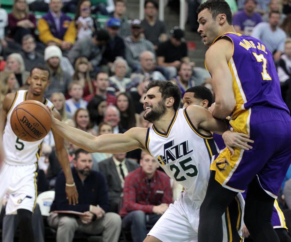 Jazz guard Raul Neto streches to grab the ball against Lakers forward Larry Nance Jr. during a game on Jan. 16.