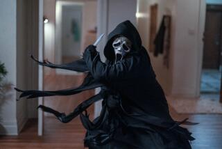 A cloaked man in a 'Scream' mask wielding a knife