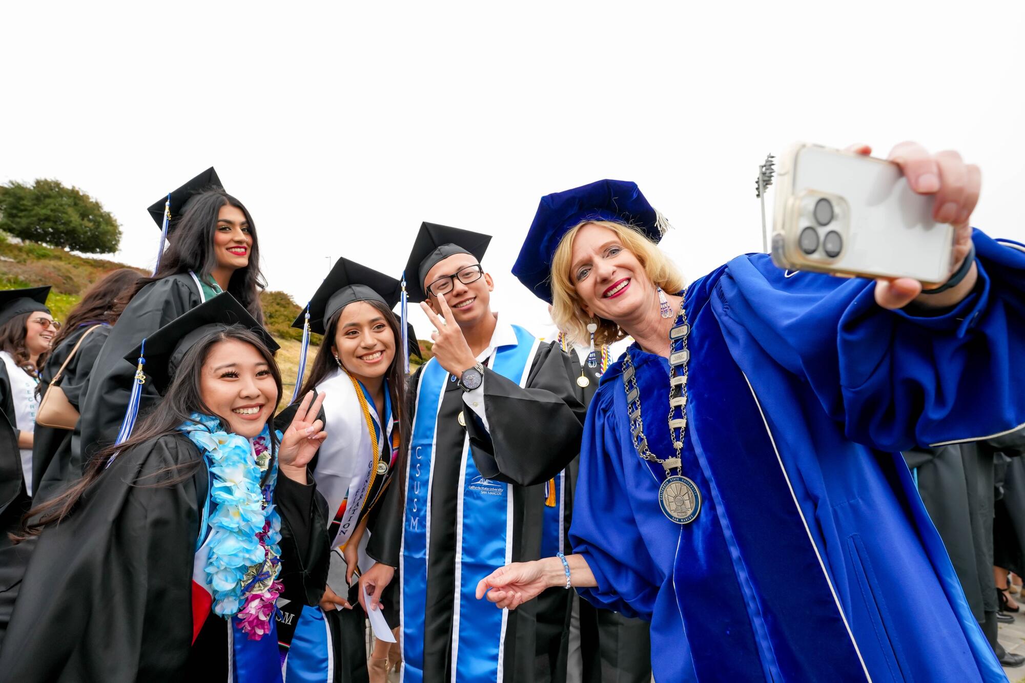 Cal State San Marcos President Ellen Neufeldt poses with graduating students during last year's commencement.