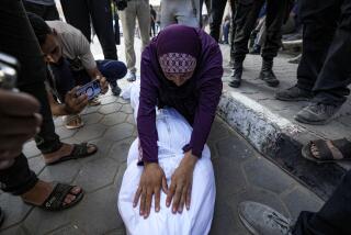 A Palestinian woman mourns a relative killed in the Israeli bombardment of the Gaza Strip at a hospital in Deir al-Balah, Friday, Aug. 30, 2024. (AP Photo/Abdel Kareem Hana)