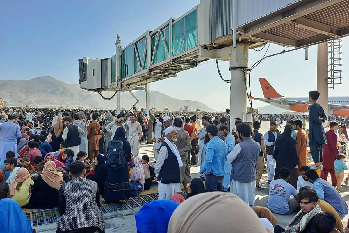 Afghans crowd the Kabul airport on Monday, trying to flee the country as the Taliban seized control. 