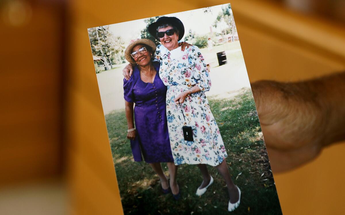 Charles Tyler holds a photo of his mom with wife Janice's mom.