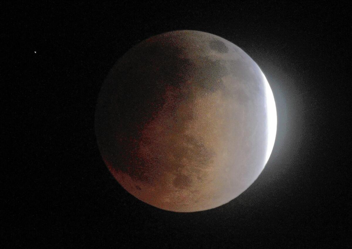 A sliver of the moon remains outside Earth's shadow during Tuesday's lunar eclipse. The moon took on a reddish glow during the event known as a "blood moon."