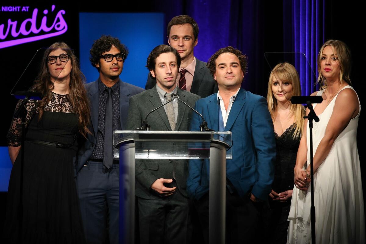 Actors Mayim Bialik, left, Kunal Nayyar, Simon Helberg, Jim Parsons, Johnny Galecki, Melissa Rauch and Kaley Cuoco-Sweeting take the stage at the 22nd "A Night at Sardi's" at the Beverly Hilton Hotel.