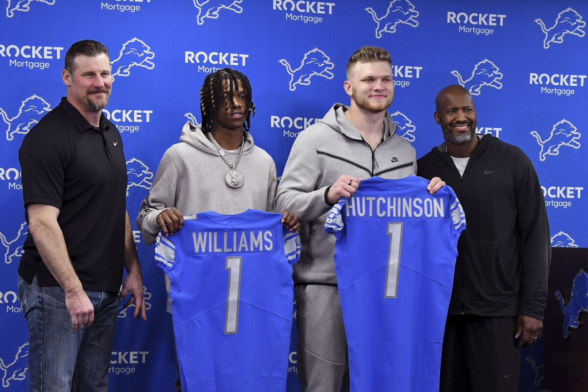 From left to right, Detroit Lions head coach Dan Campbell, NFL football first-round draft picks Jameson Williams and Aidan Hutchinson and general manager Brad Holmes pose at the team's training facility, April 29, 2022 in Allen Park, Mich. (Robin Buckson/Detroit News via AP)