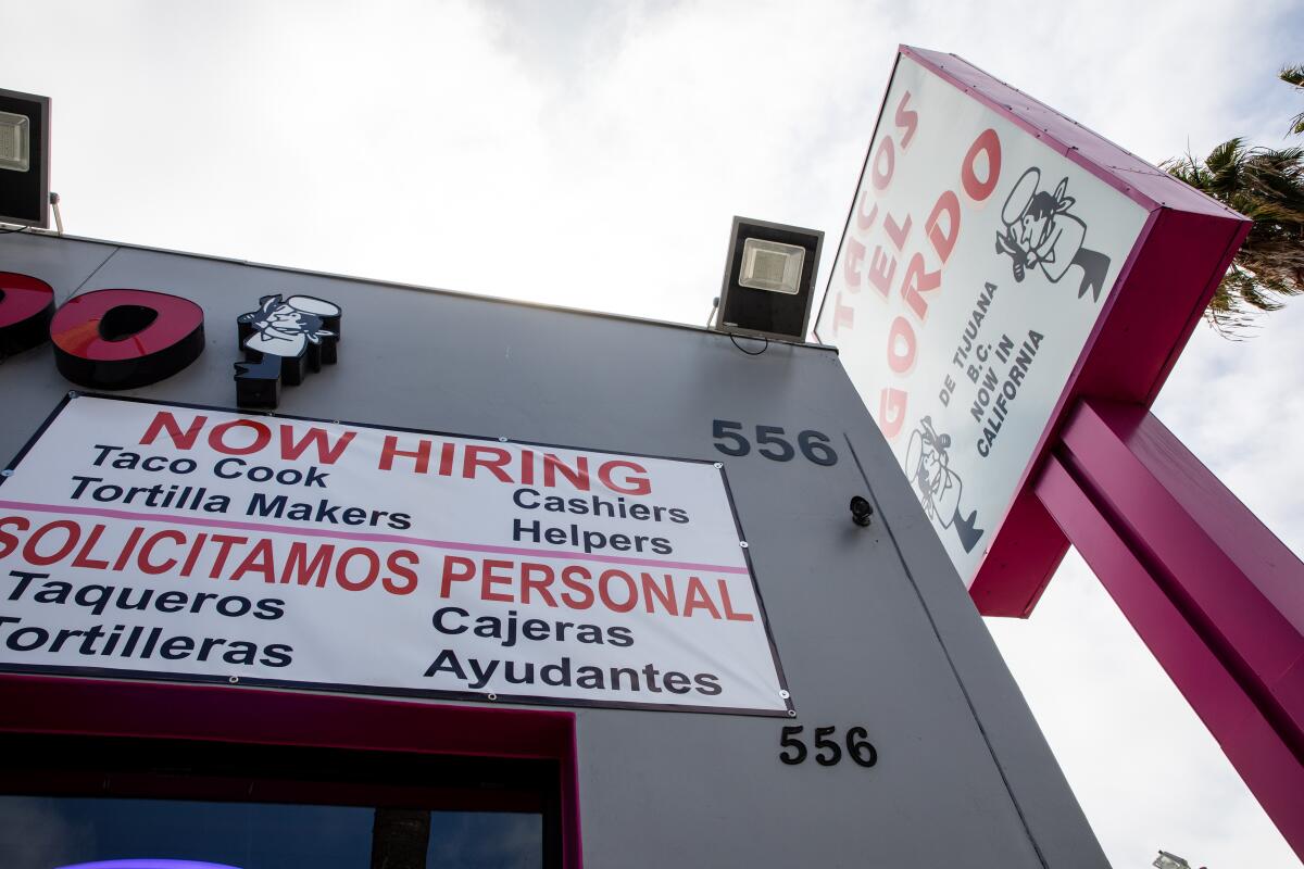 A hiring sign is posted outside Tacos El Gordo in Chula Vista on Thursday, June 3