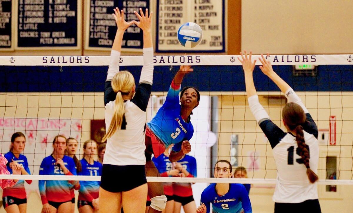 Marymount's Dior Charles pounds ball through Sierra Canyon blockers Danica Rach and Madeline Way.