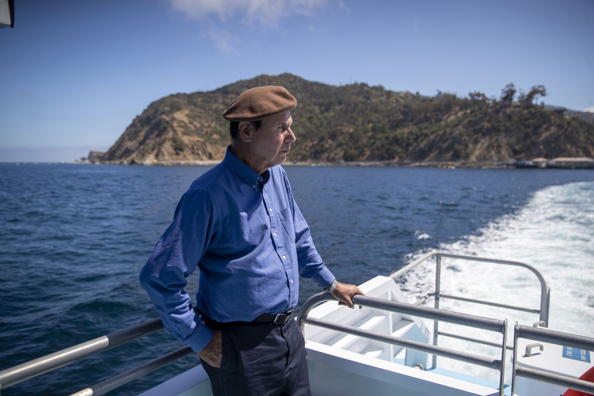 David Sanchez, wearing a brown beret, looks back at Avalon while aboard the Catalina Express ferry