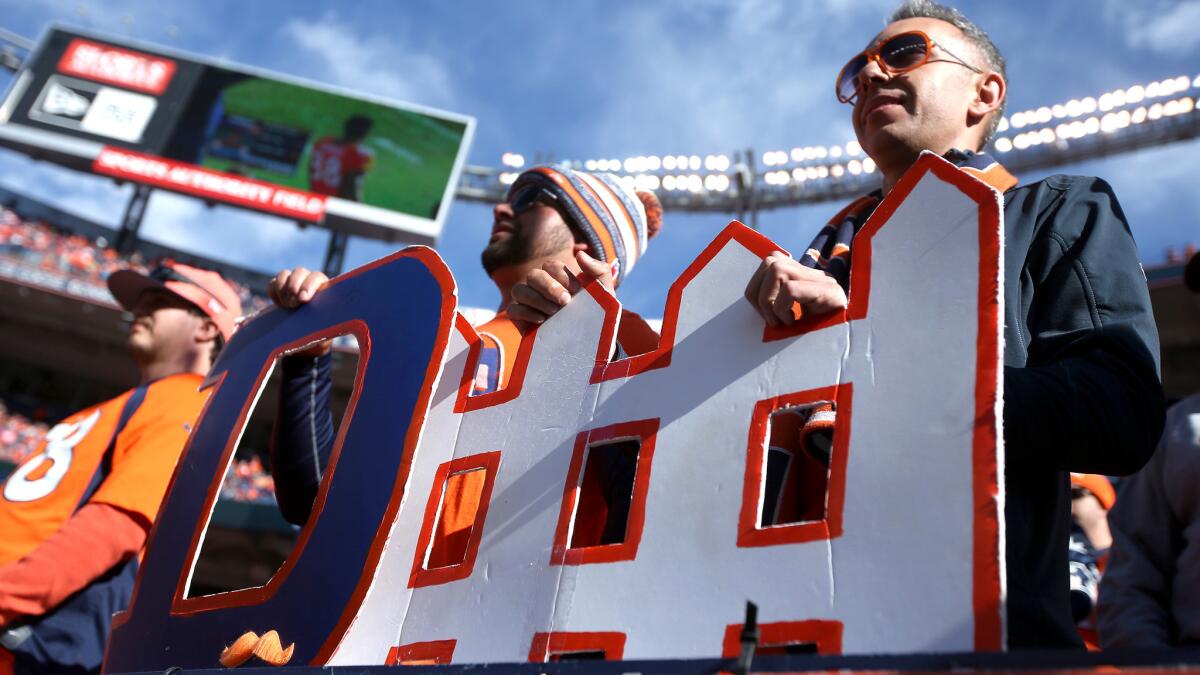 Fans hold a 'defense' sign before Denver's victory over New England in the AFC championship game. The Broncos had the NFL's top-ranked defense this season and face the Panthers' top-scoring offense in Super Bowl 50.