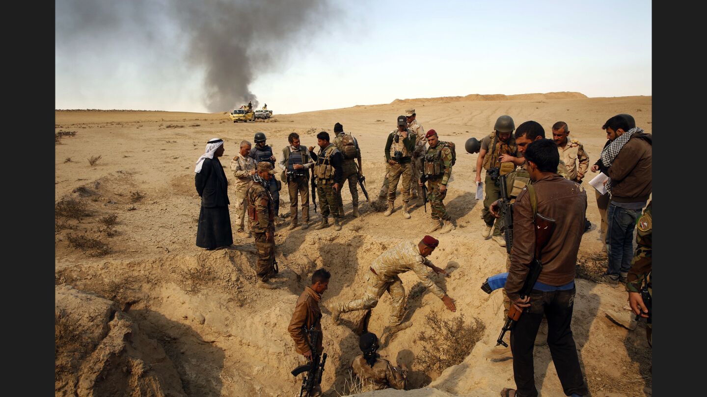 On the outskirts of the village of Al Hud, members of the Iraqi Army visit an area where locals say ISIS executed four or five Peshmerga in recent months. Soldiers said another grave site containing more bodies was in the area but was too dangerous to access due to mines.