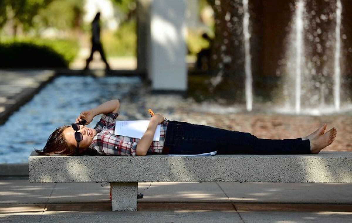 The 5% tuition hike — equal to $150 per semester — would raise an estimated $58 million in revenue in fiscal 2012-13, officials said. Above, graduate student Joan Lim relaxes at Cal State Long Beach.