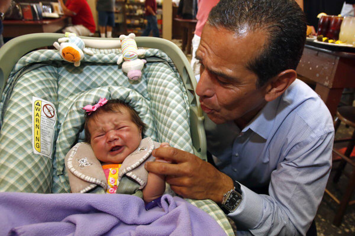 Villaraigosa with 3-week-old Mary Galloway while visiting Philippe's.