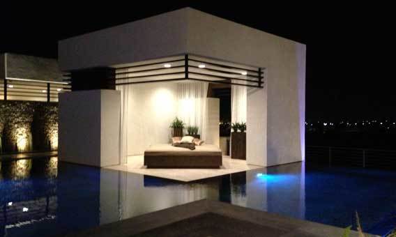 An outdoor room flush with the water level juts into the swimming pool.