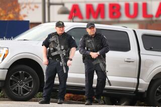 Lewiston, ME - October 26: Heavily armed police stand at the ambulance entrance to the Central Maine Medical Center in Lewiston where many of the shooting victims were brought. (Photo by John Tlumacki/The Boston Globe via Getty Images)